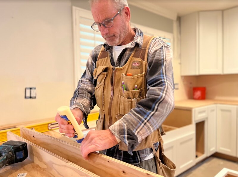 Carpenter applying professional wood glue