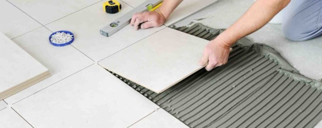 professional tiler installing ceramic tiles