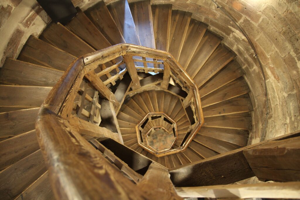 artisan shaping wood spiral staircase