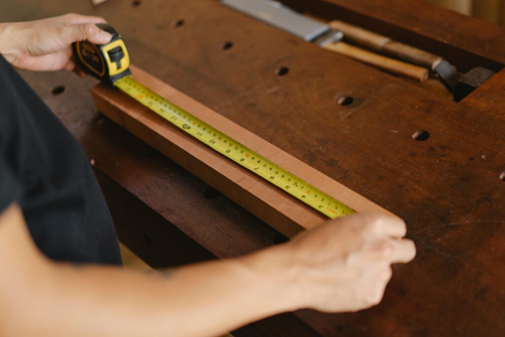 skilled carpenter measuring custom joinery